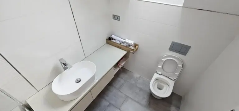Tiszta fürdőszoba mosdóval és WC-vel felújítás utáni takarítás után